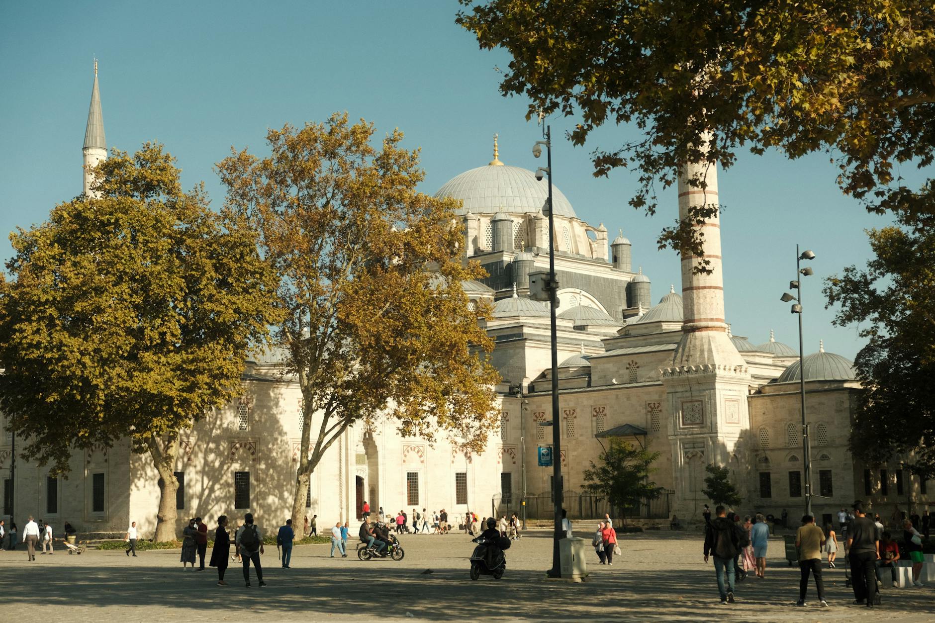 Crowds walking across Beyazıt Square in front of the historic Beyazıt Mosque in Istanbul.