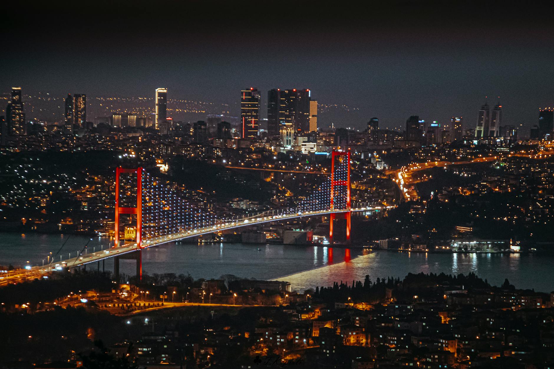 Illuminated Bosphorus Bridge at night connecting the European and Asian sides of Istanbul.
