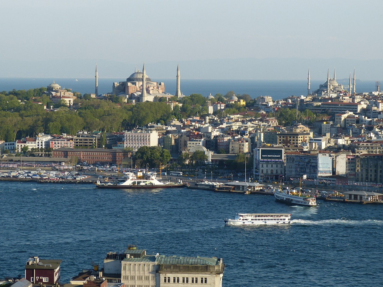 A panoramic aerial view of the Golden Horn waterway and the Istanbul city skyline.
