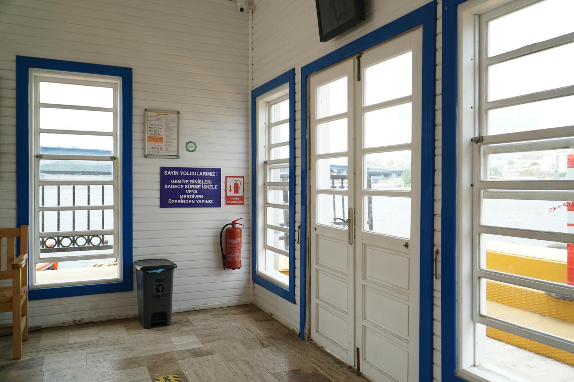 Interior view of a Golden Horn ferry boarding area with Turkish instructional signage.