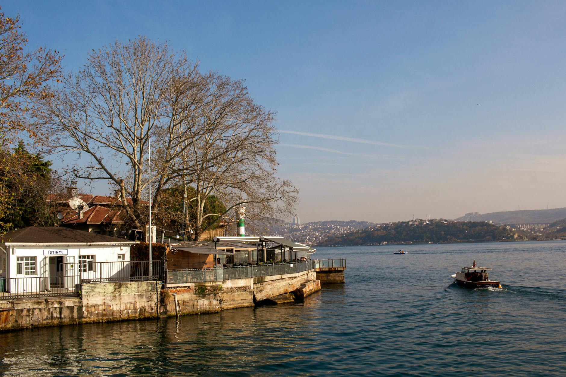 A sunny day at the Istinye ferry terminal overlooking the blue Bosphorus waters.