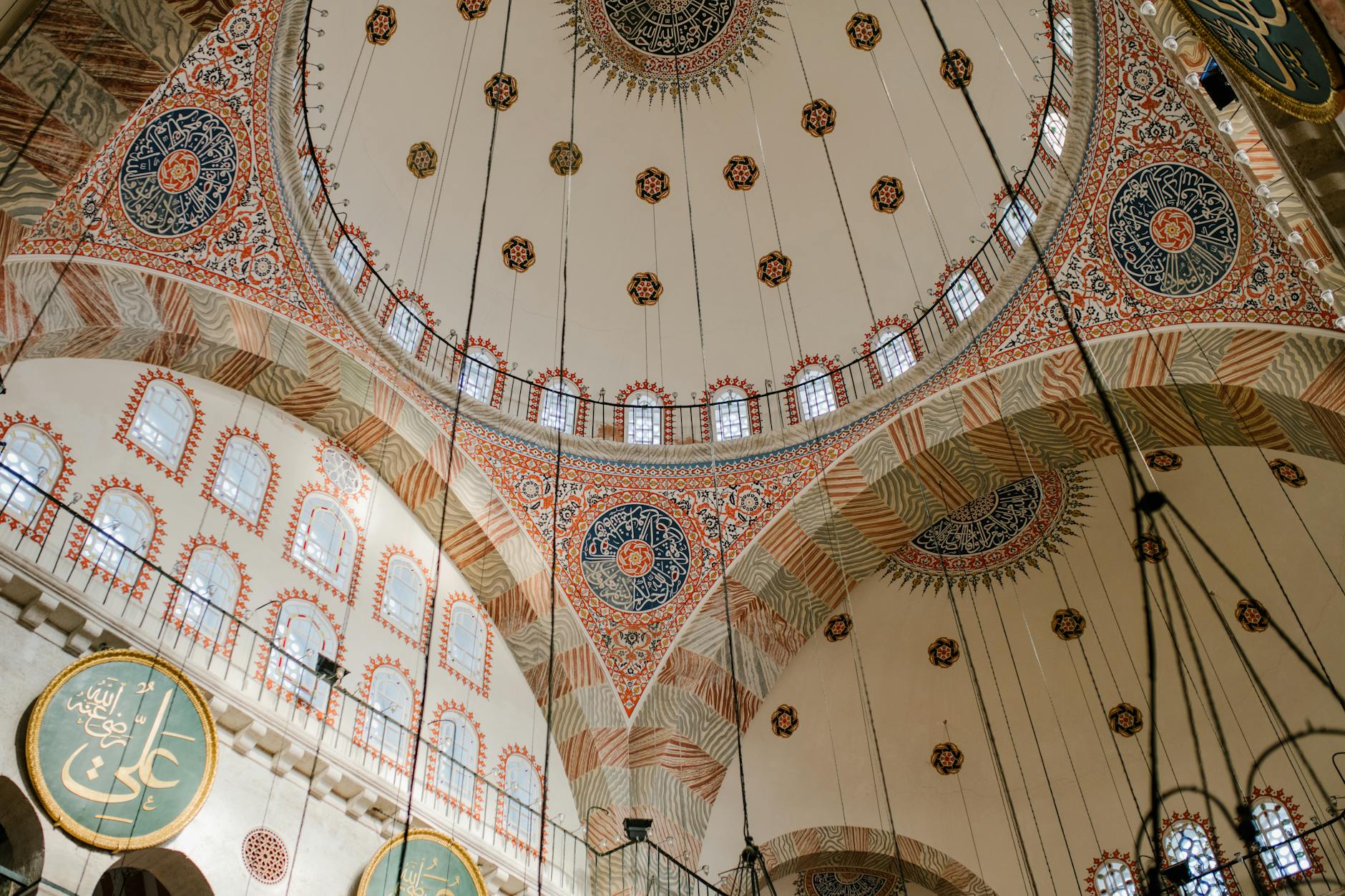 Detailed interior view of the decorated dome and calligraphy in Kilic Ali Pasha Mosque.
