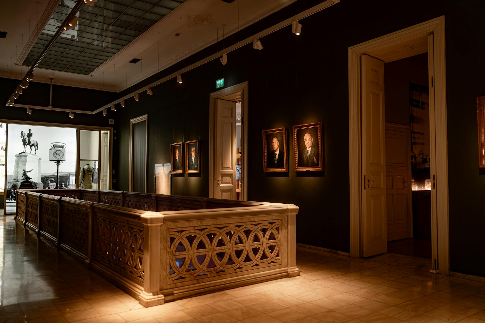 Elegant interior view of the Pera Museum with historic portraits and marble railings.