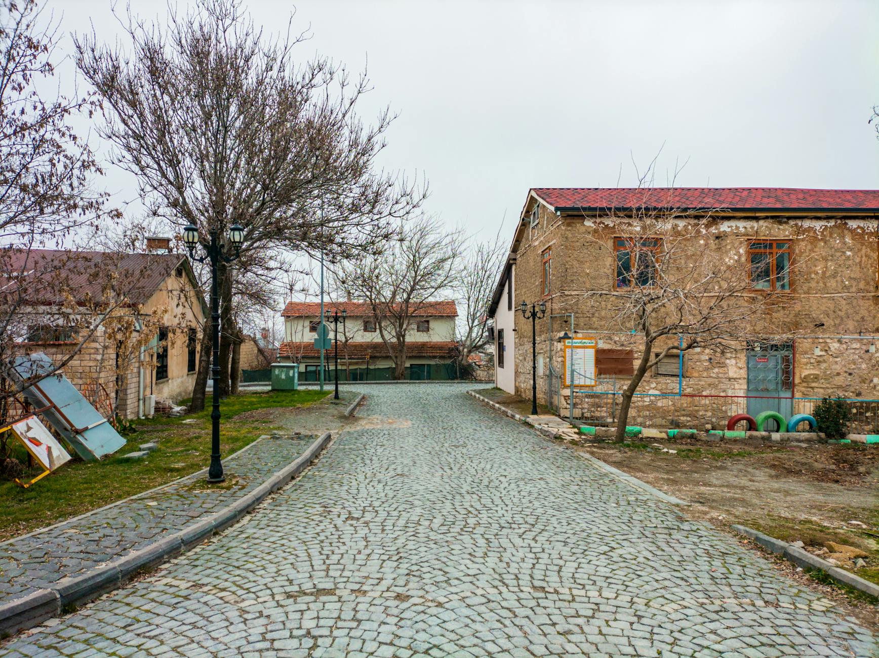 A small local PTT post office branch building located in a rural Turkish village.