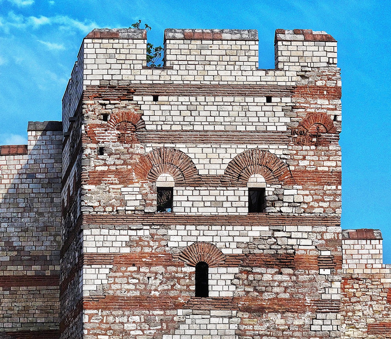 Restored tower of the Theodosian Land Walls with stone and brick bands.