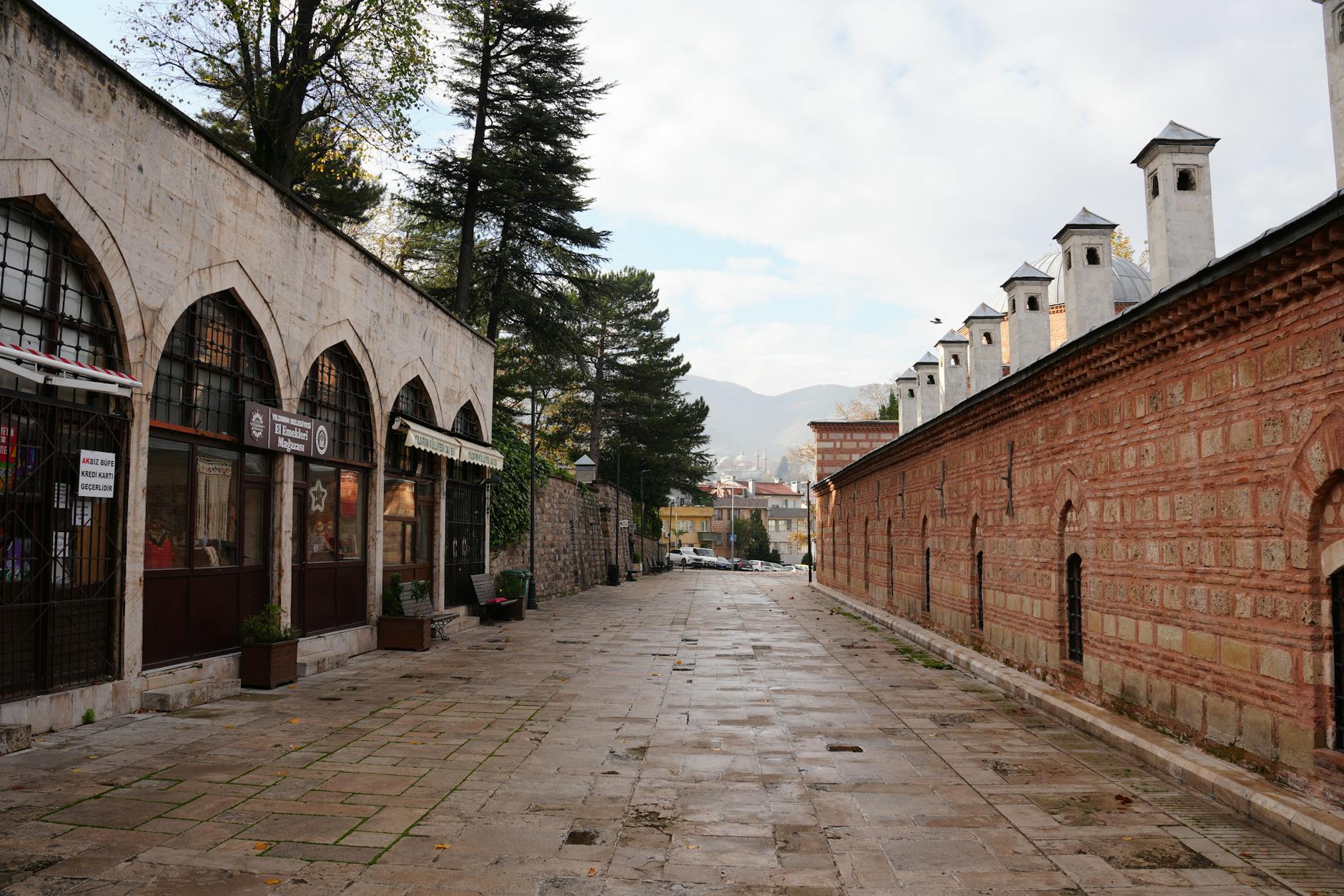 Exterior view of a historical stone Turkish bath building with traditional chimneys.
