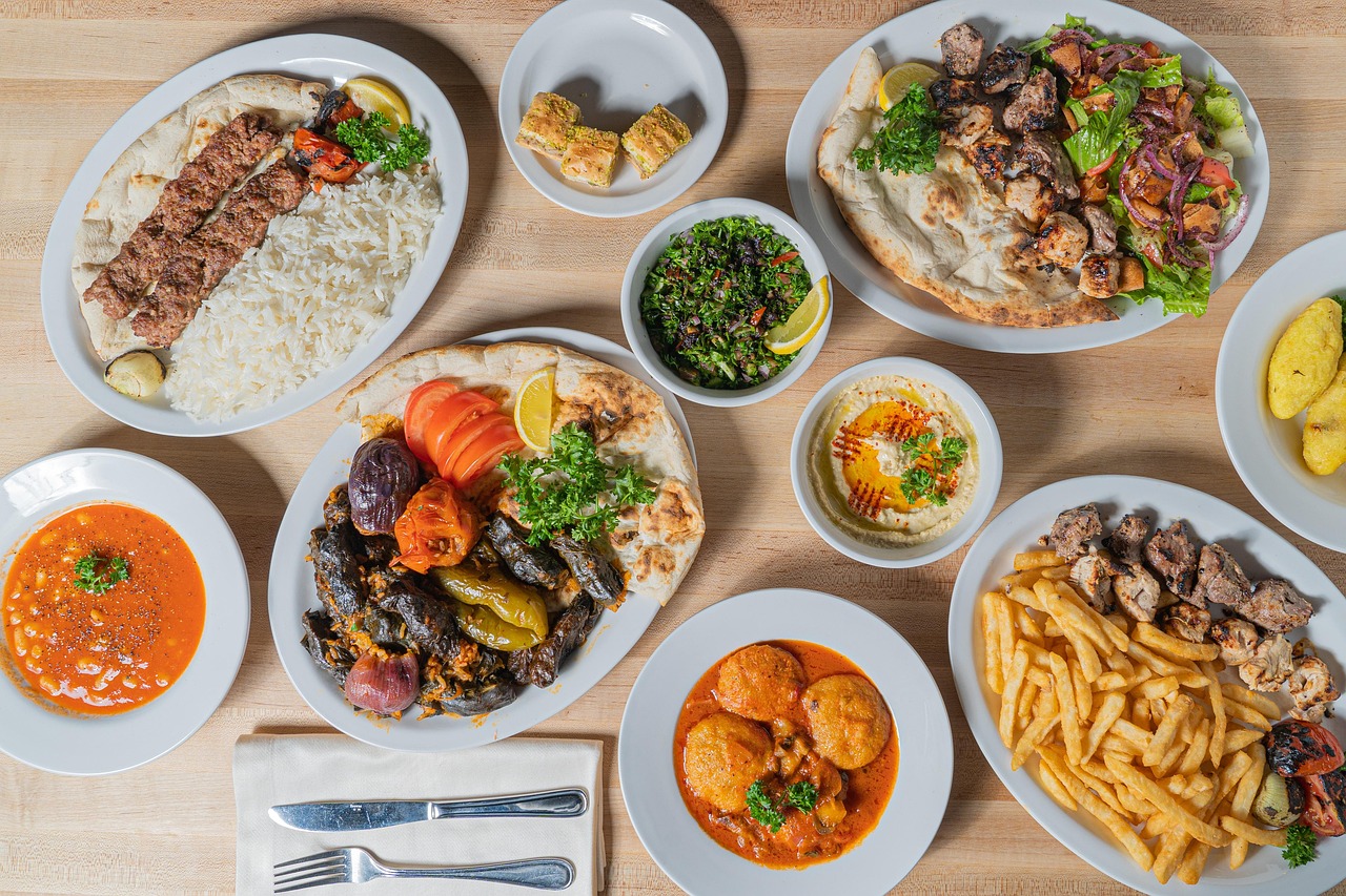 An abundant Turkish feast featuring various kebabs, dolma, hummus, and traditional desserts.