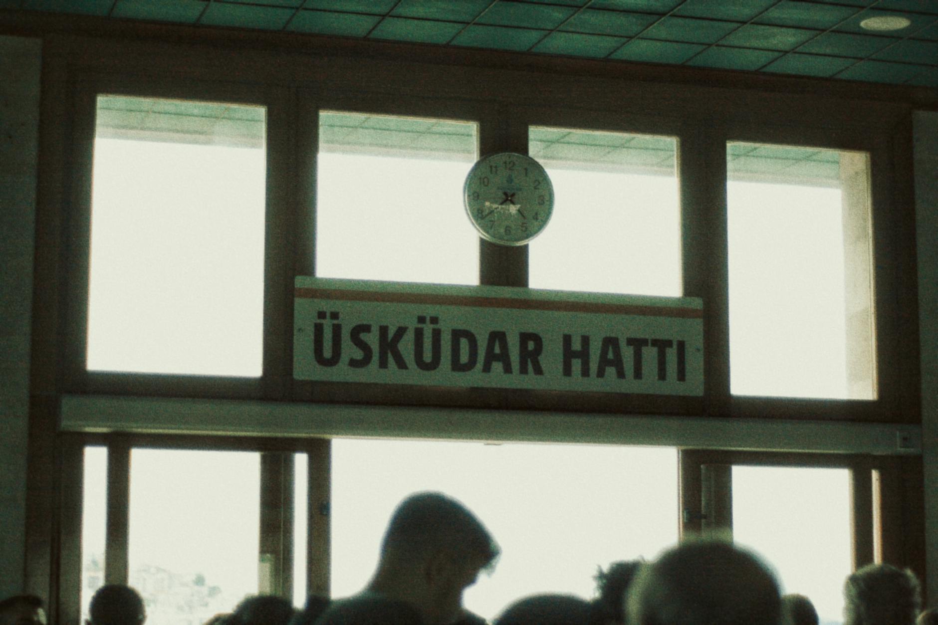 A sign for the Üsküdar ferry line inside an Istanbul passenger terminal.